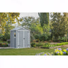 Image of Gray garden shed in a garden setting with trees and plants.