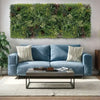 Image of Blue sofa with decorative pillows in a living room setting with a triptych green wall feature.