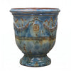 Image of Decorative ceramic planter with blue glaze and rustic design on a white background