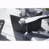 Image of Black chair with a cup holder on a wooden deck