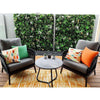 Image of Wild Tropics Artificial Vertical Garden Panel featured on a patio with a table and chair setting