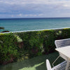 Image of Artificial Premium Fern & Grass Vertical Garden installed on a rooftop balcony overlooking the beach