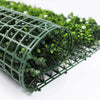 Image of artificial flowering buxus panel rolled up showing its flexibility