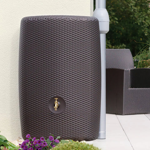 Wicker outdoor minitank with a tap on a patio setting.