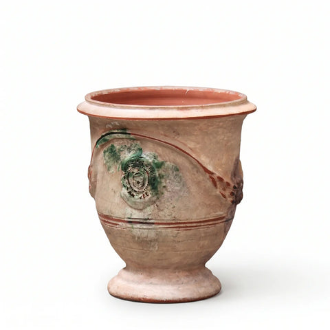 Terracotta pot with greenish-brown glaze on a white background