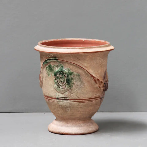 Vintage ceramic vase with green accents on a gray background