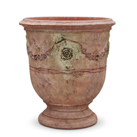 Terracotta pot with decorative patterns on a white background