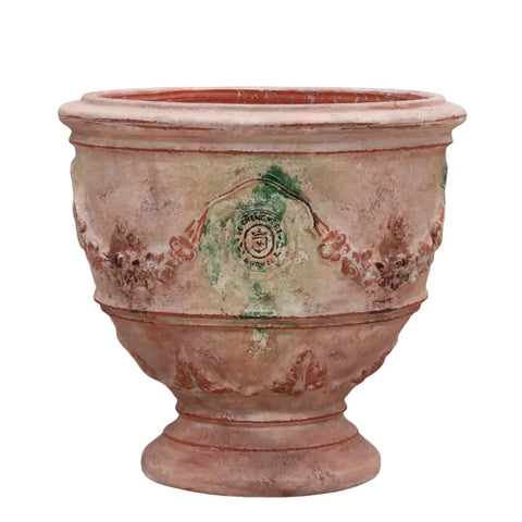 Terracotta pot with decorative patterns on a white background