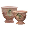 Image of Two terracotta pots with decorative designs on a white background