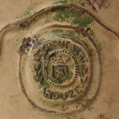 Decorative motiff close up with 'Le Chene Vert Anduze' branding and design.