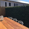Image of Artificial Laurel Trellis Installed On Deck With Table In Foreground
