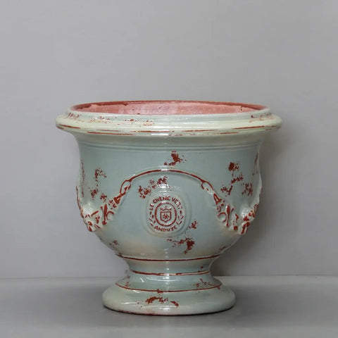 Ceramic vase with red floral patterns on a white background
