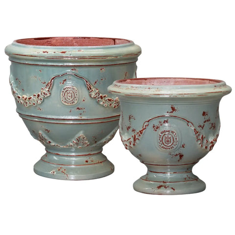 Two decorative urns with a light blue and red pattern on a white background
