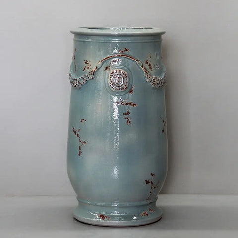 Decorative ceramic vase with floral patterns on a plain background
