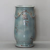 Image of Decorative ceramic vase with floral patterns on a plain background