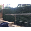Image of Artificial Premium Natural Buxus Panel installed at a laundry area with the cloth drying rack