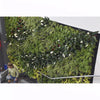 Image of Large green artificial plant wall with a person standing below on a white background