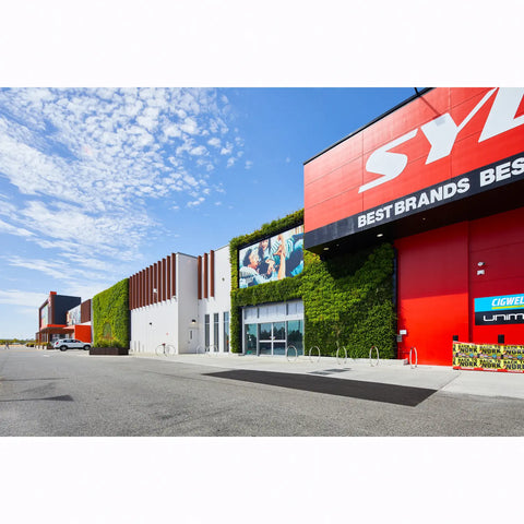 Sydney tools store exterior with gro wall slim pro green wall facade and 'Best Brands' sign against a blue sky.