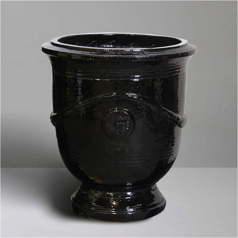 Black ceramic urn on a gray background