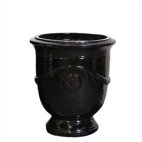 Black medium ceramic planter with decorative ribbing on a white background