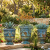 Image of Three decorative blue urns with plants in a garden setting