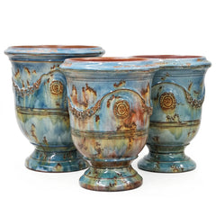 Three ceramic pots with decorative patterns on a white background