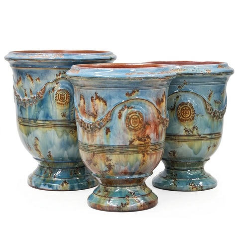 Three ceramic pots with decorative patterns on a white background