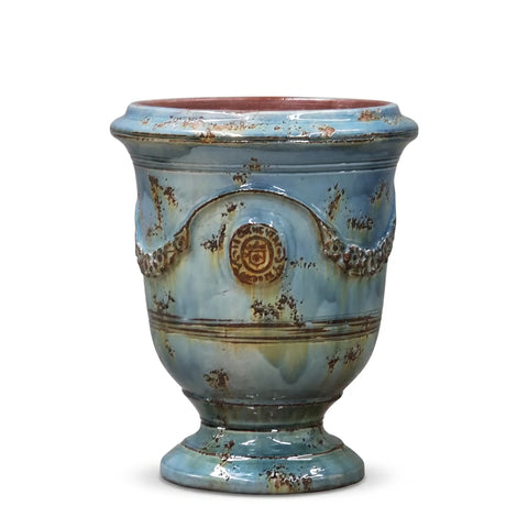Decorative ceramic vase with blue glaze and brown accents on a white background