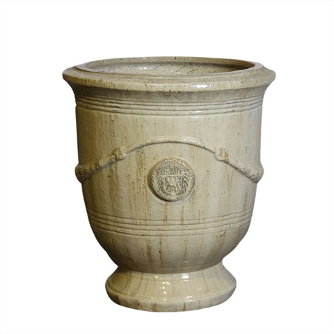 Large sand ceramic french urn planter with decorative elements on a white background