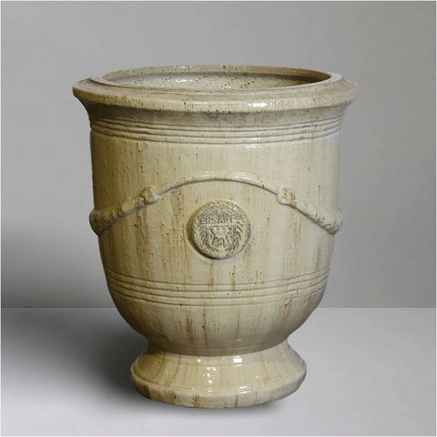 Decorative sand french ceramic urn with decorative elements on a grey background