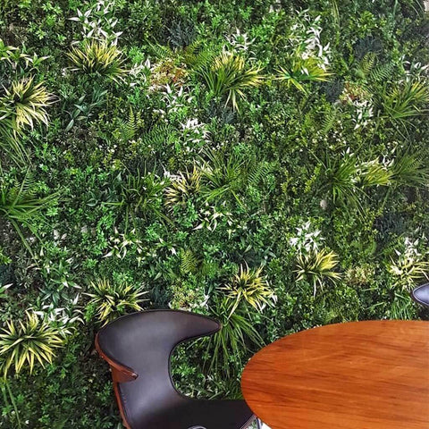 Artificial Lush Forest Panel Installed With A Table and Chair in foreground